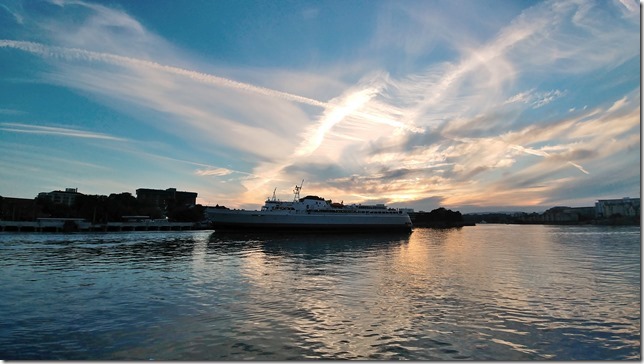 Setting sun as MV Coho backs out of her berth in James Bay