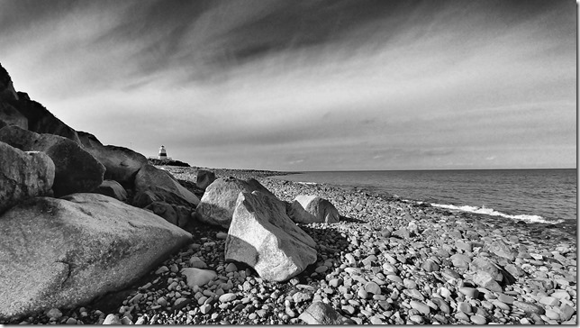 Margaretsville Lighthouse viewed from the cobble beach at low tide